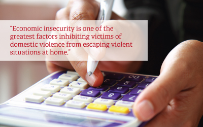 Person typing on calculator - text reads:Economic insecurity is one of the greatest factors inhibiting victims of domestic violence from escaping violent situations at home.