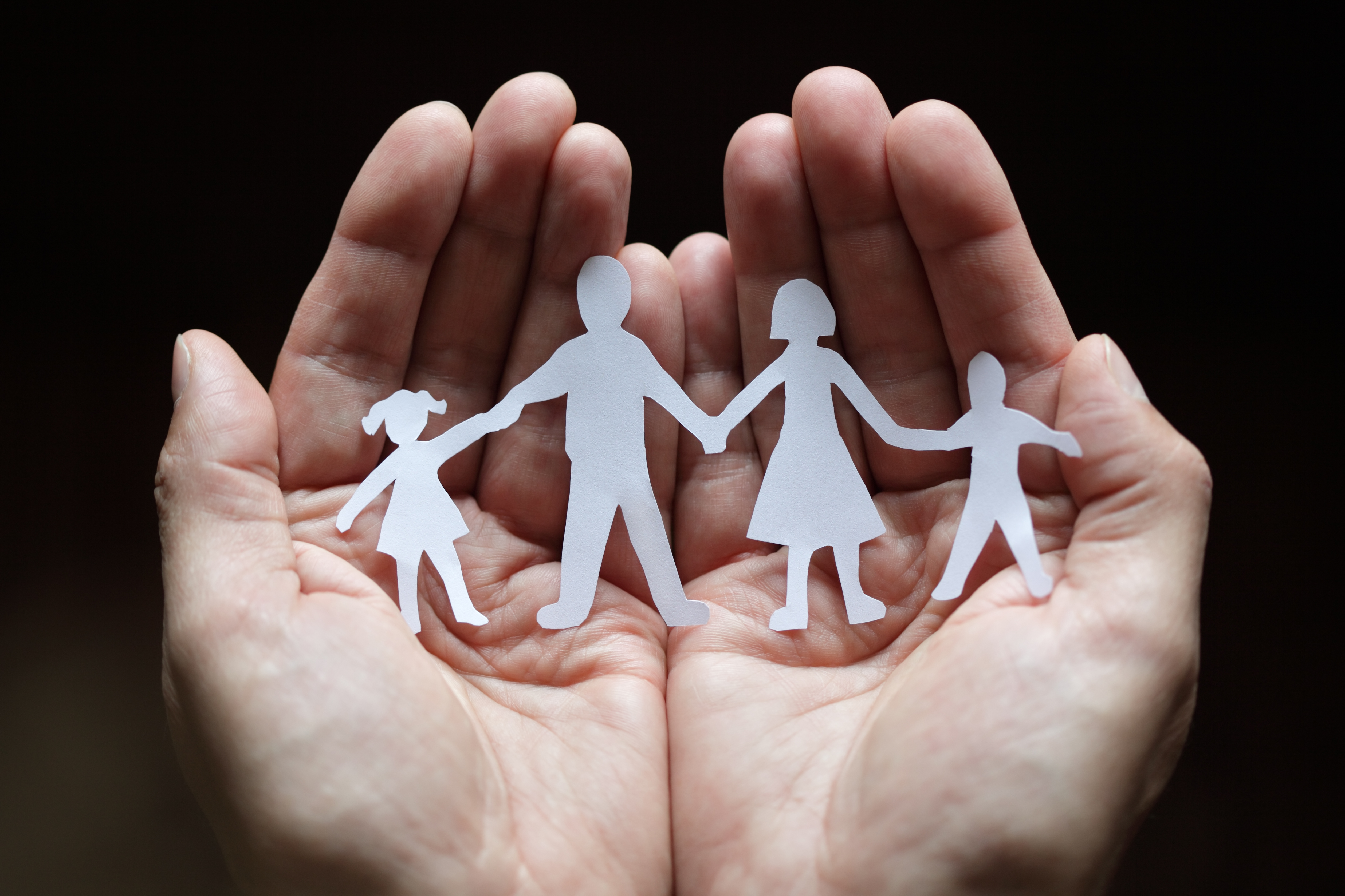 cut out paper family being held